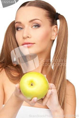 Image of young beautiful woman with green apple