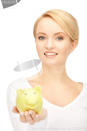 Image of lovely woman with piggy bank