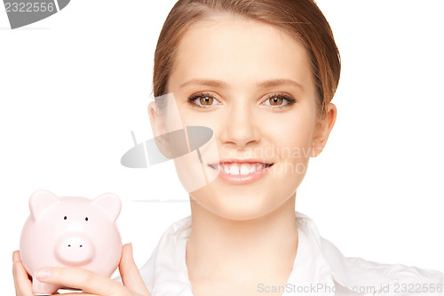 Image of lovely woman with piggy bank