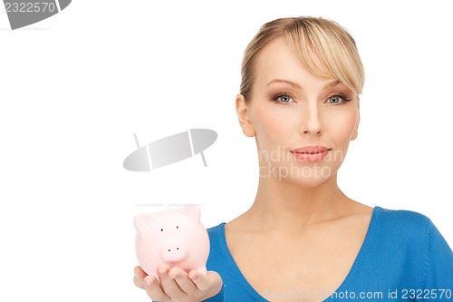 Image of lovely woman with piggy bank