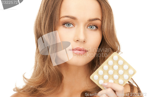 Image of young beautiful woman with pills 