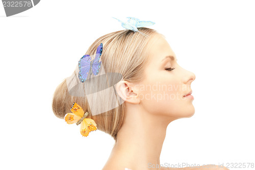 Image of beautiful woman with butterfly in hair