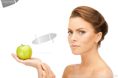 Image of young beautiful woman with green apple