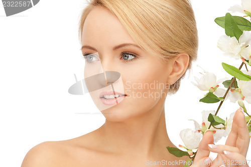 Image of beautiful woman with orchid flower