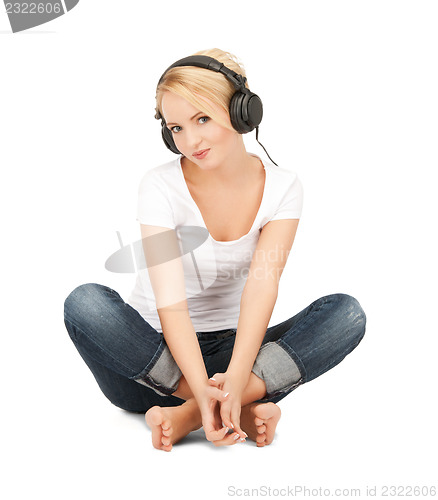 Image of  happy teenage girl in big headphones