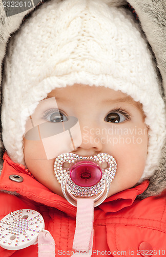 Image of adorable baby with pacifier