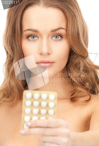 Image of young beautiful woman with pills