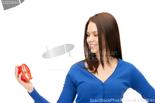 Image of woman holding alarm clock