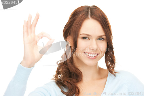 Image of lovely teenage girl showing ok sign