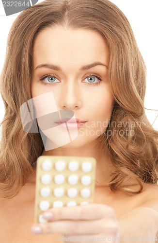 Image of young beautiful woman with pills 