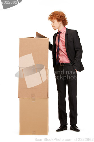 Image of attractive businessman with big boxes