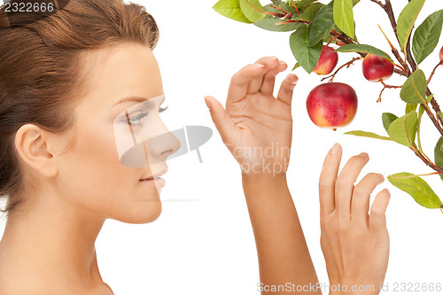 Image of lovely woman with apple twig