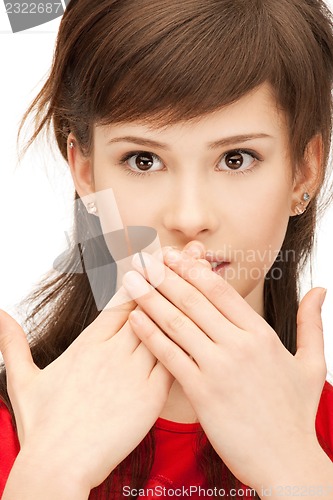 Image of teenage girl with palms over mouth