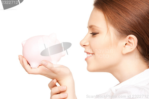 Image of lovely woman with piggy bank