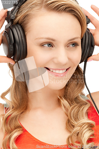 Image of happy teenage girl in big headphones