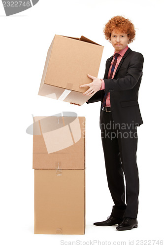 Image of attractive businessman with big boxes