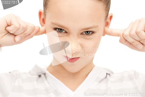 Image of teenage girl with fingers in ears