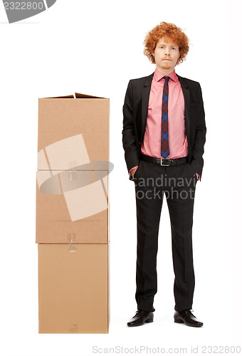 Image of attractive businessman with big boxes