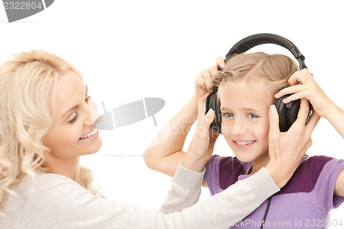 Image of mother and little girl with headphones