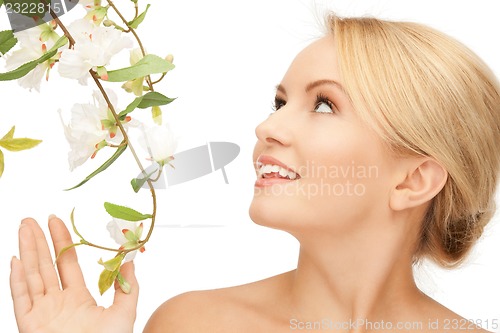Image of beautiful woman with orchid flower