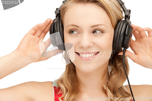 Image of happy teenage girl in big headphones