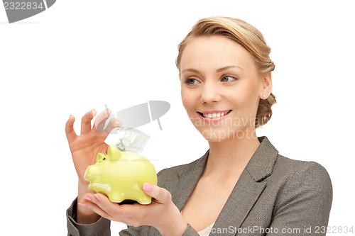 Image of lovely woman with piggy bank and money