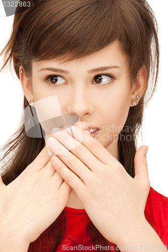 Image of teenage girl with palms over mouth