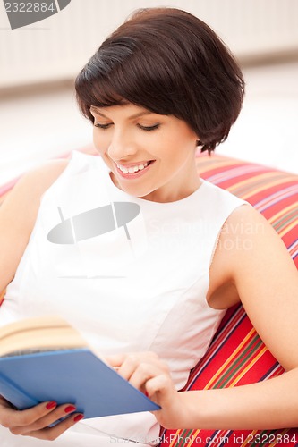Image of happy and smiling woman with book