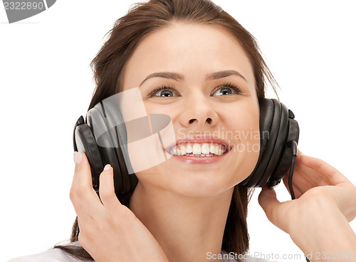 Image of happy teenage girl in big headphones