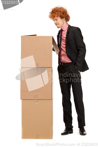 Image of attractive businessman with big boxes