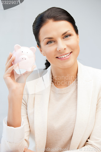 Image of lovely woman with piggy bank