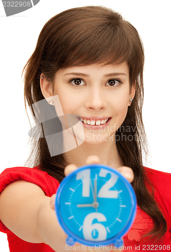 Image of teenage girl holding alarm clock