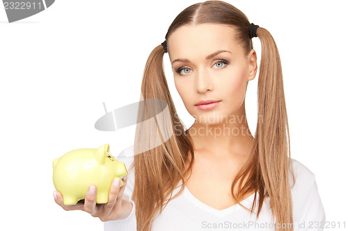 Image of lovely woman with piggy bank