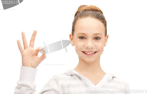 Image of lovely teenage girl showing ok sign