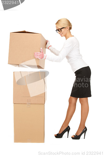 Image of attractive businesswoman with big boxes