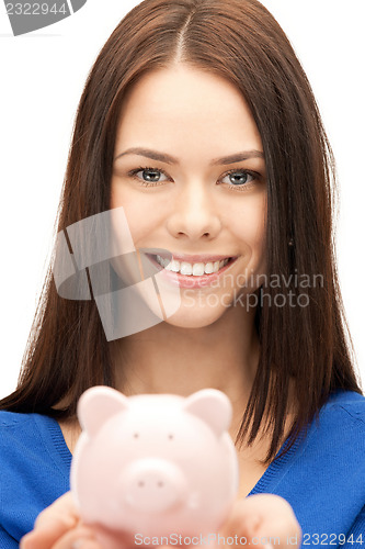 Image of lovely woman with piggy bank