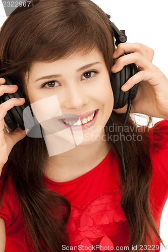 Image of happy teenage girl in big headphones
