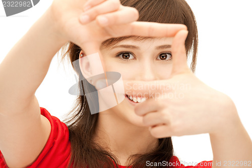 Image of teenage girl creating a frame with fingers