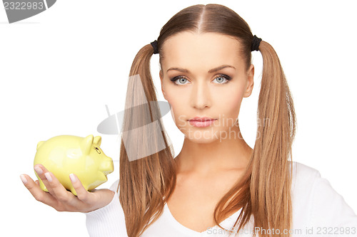 Image of lovely woman with piggy bank