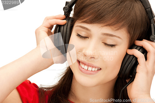 Image of happy teenage girl in big headphones