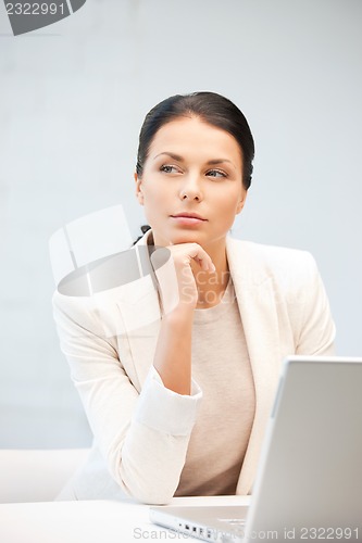 Image of pensive woman with laptop computer