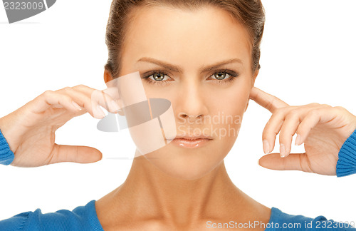 Image of woman with fingers in ears