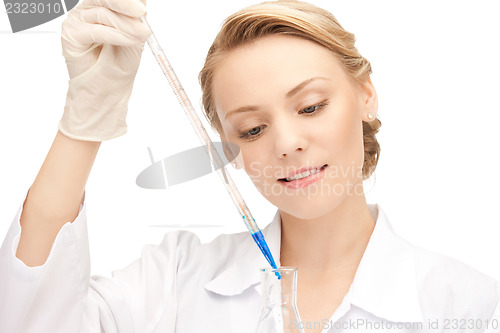 Image of lab worker holding up test tube