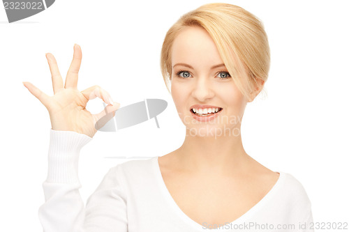 Image of lovely teenage girl showing ok sign
