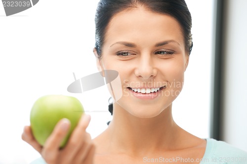 Image of lovely housewife with green apple