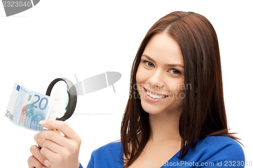 Image of woman with magnifying glass and euro cash money