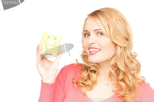 Image of lovely woman with piggy bank