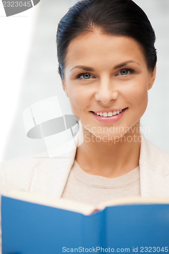 Image of happy and smiling woman with book