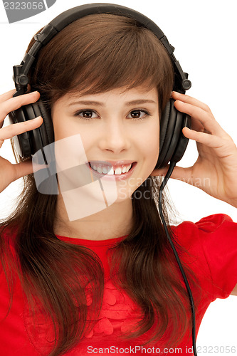 Image of happy teenage girl in big headphones