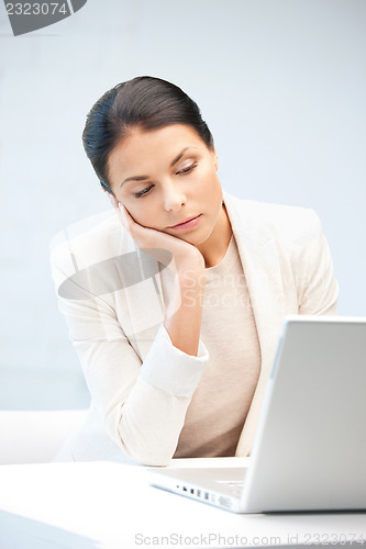 Image of pensive woman with laptop computer